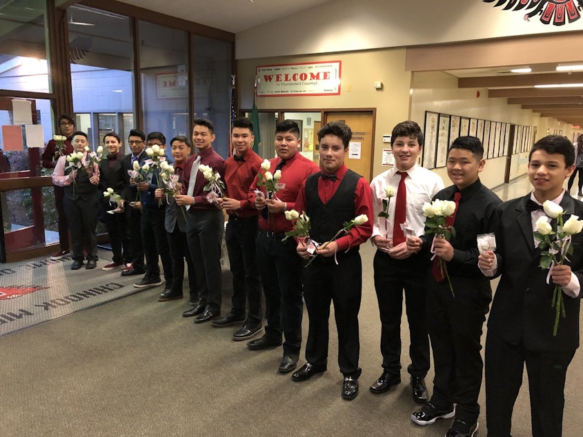 caption: The members of Los Siete on Valentine's Day, dressed up and ready to hand out roses to everyone at Chinook Middle School. This is the fifth year they've followed this tradition.