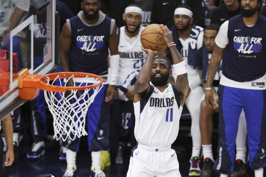 caption: Kyrie Irving, point guard for the Dallas Mavericks, shoots in game five of the Western Conference final. (Matt Krohn/AP)