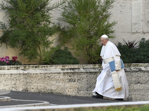 caption: Pope Francis arrives for the opening of a sexual-abuse prevention summit at the Vatican on Thursday.