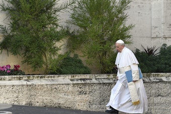caption: Pope Francis arrives for the opening of a sexual-abuse prevention summit at the Vatican on Thursday.
