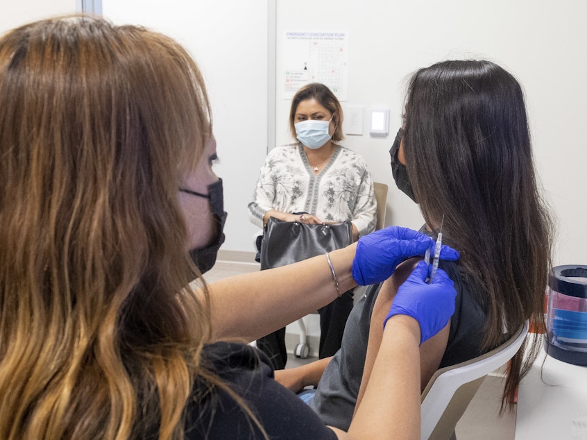 caption: A 16-year-old gets a Pfizer-BioNTech COVID-19 vaccine in Anaheim, Calif., on April 28. Advisers to the Centers for Disease Control and Prevention now say it's not necessary for adolescents to wait two weeks after a COVID shot to receive routine immunizations.