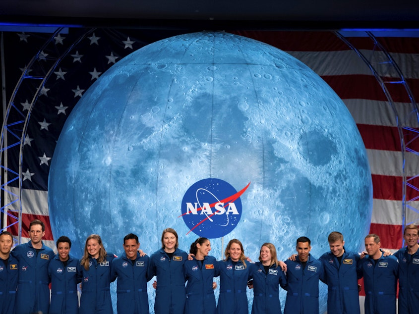 caption: NASA's ambitions for putting astronauts on the moon have been delayed. Here, newly minted astronauts from NASA and the Canadian Space Agency are seen last year. They're the first candidates to graduate under the Artemis program, and could be eligible for assignments including the Artemis missions to the Moon, International Space Station, and missions to Mars.