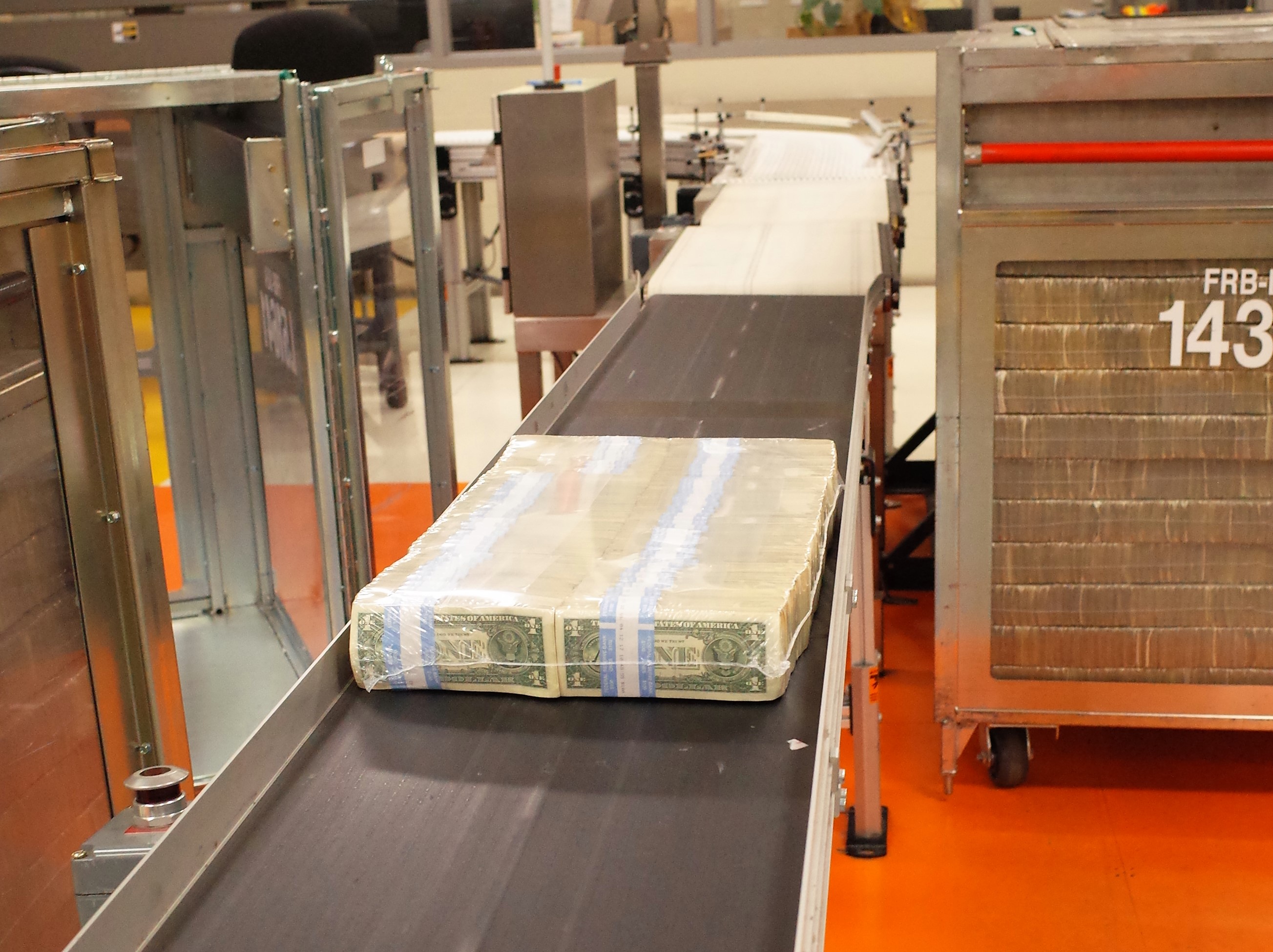 caption: Cash that survived the ultra-fine shredder is sorted, packed and then shrinkwrapped before becoming just another anonymous layer of cash in a crate.