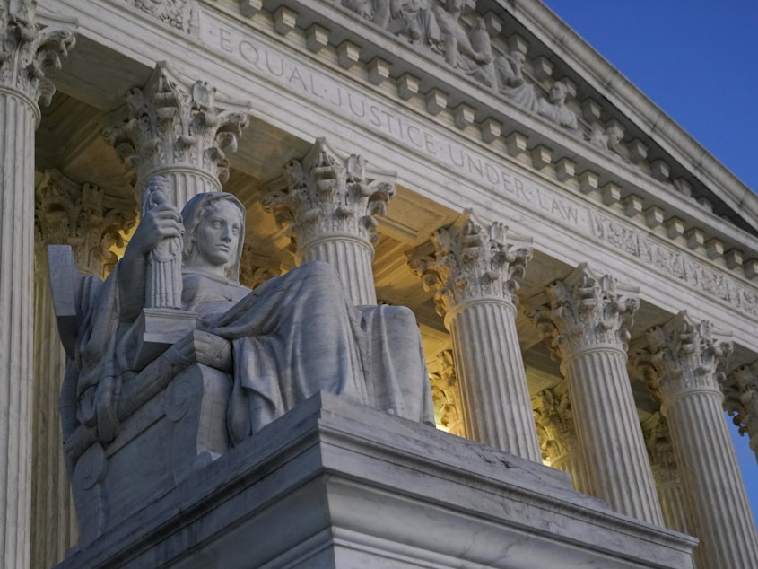 caption: Light illuminates part of the Supreme Court building in Washington on Nov. 16, 2022.