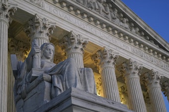caption: Light illuminates part of the Supreme Court building in Washington on Nov. 16, 2022.