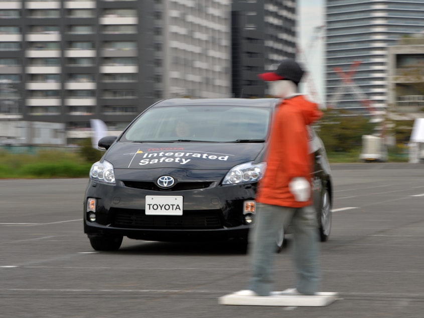 caption: Toyota demonstrates its "pre-collision system," which uses automatic steering in addition to automatic braking to prevent collisions, in Tokyo in 2013. Different manufacturers use different names for systems like this, which can be confusing, a AAA report found.