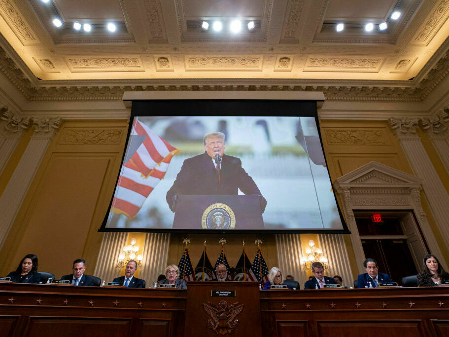 caption: Former President Donald Trump is displayed on a screen during a meeting of the Select Committee to Investigate the Jan. 6 Attack on the U.S. Capitol on Monday.