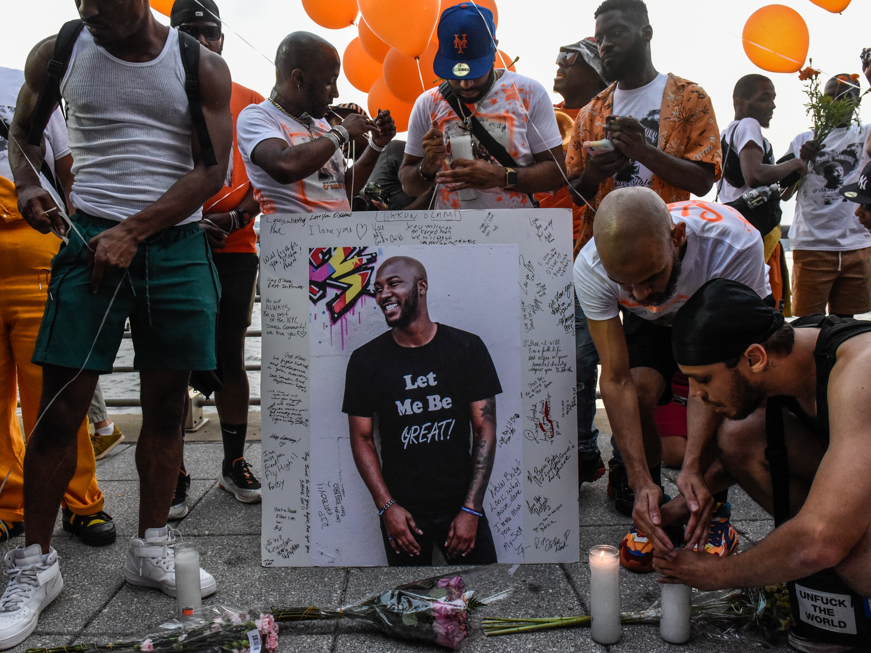 caption: A makeshift memorial honored O'Shae Sibley in New York City earlier this month.