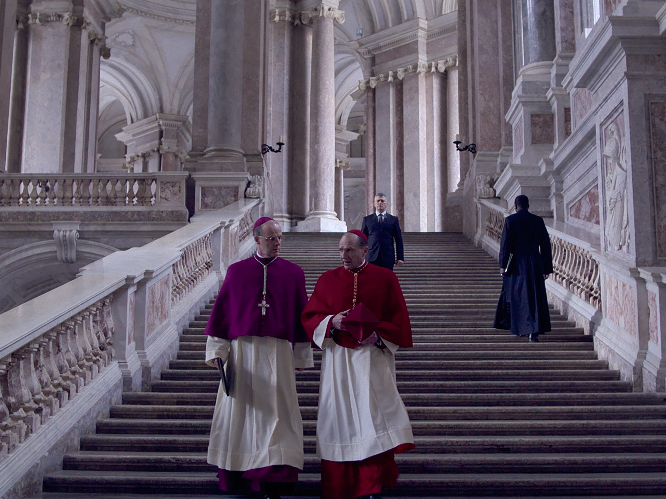 caption: Cardinal Lawrence (Ralph Fiennes) oversees the contingent that will select the next pope in <em>Conclave</em>.