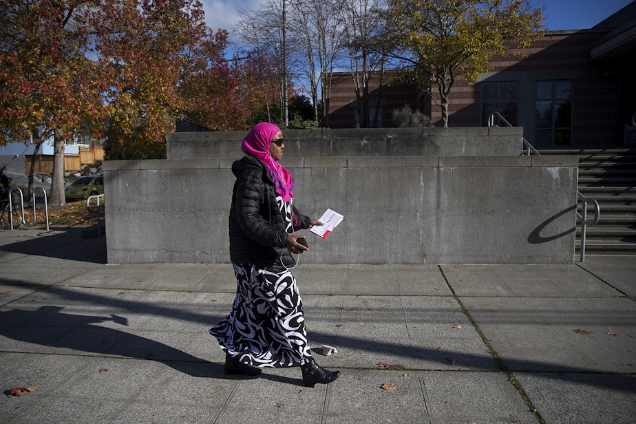 caption: Sadiya Ali walks to the ballot drop box to vote on Tuesday, November 6, 2018, in front of the Rainier Beach Community Center in Seattle. 
