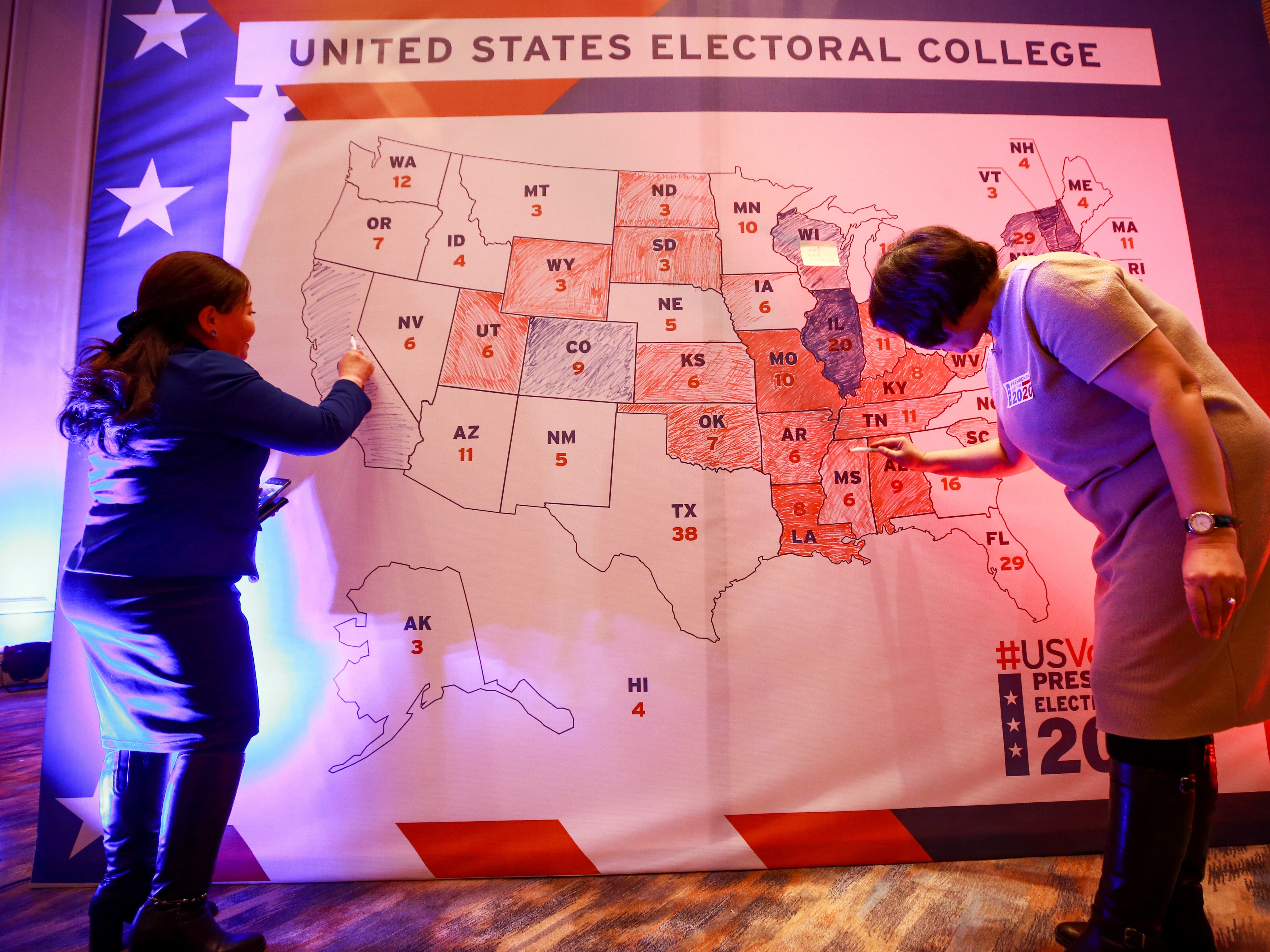 caption: People color in a U.S. electoral map during a 2020 presidential election watch party at the U.S. Embassy in Ulaanbaatar, Mongolia.