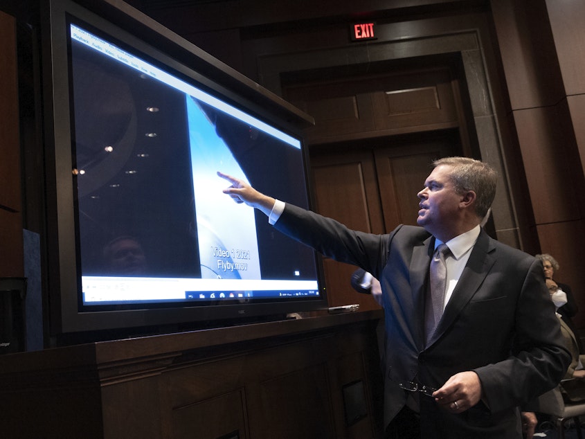 caption: U.S. Deputy Director of Naval Intelligence Scott Bray explains a video of an unidentified aerial phenomena, as he testifies before a House Intelligence Committee subcommittee hearing at the U.S. Capitol on May 17, 2022 in Washington, DC.
