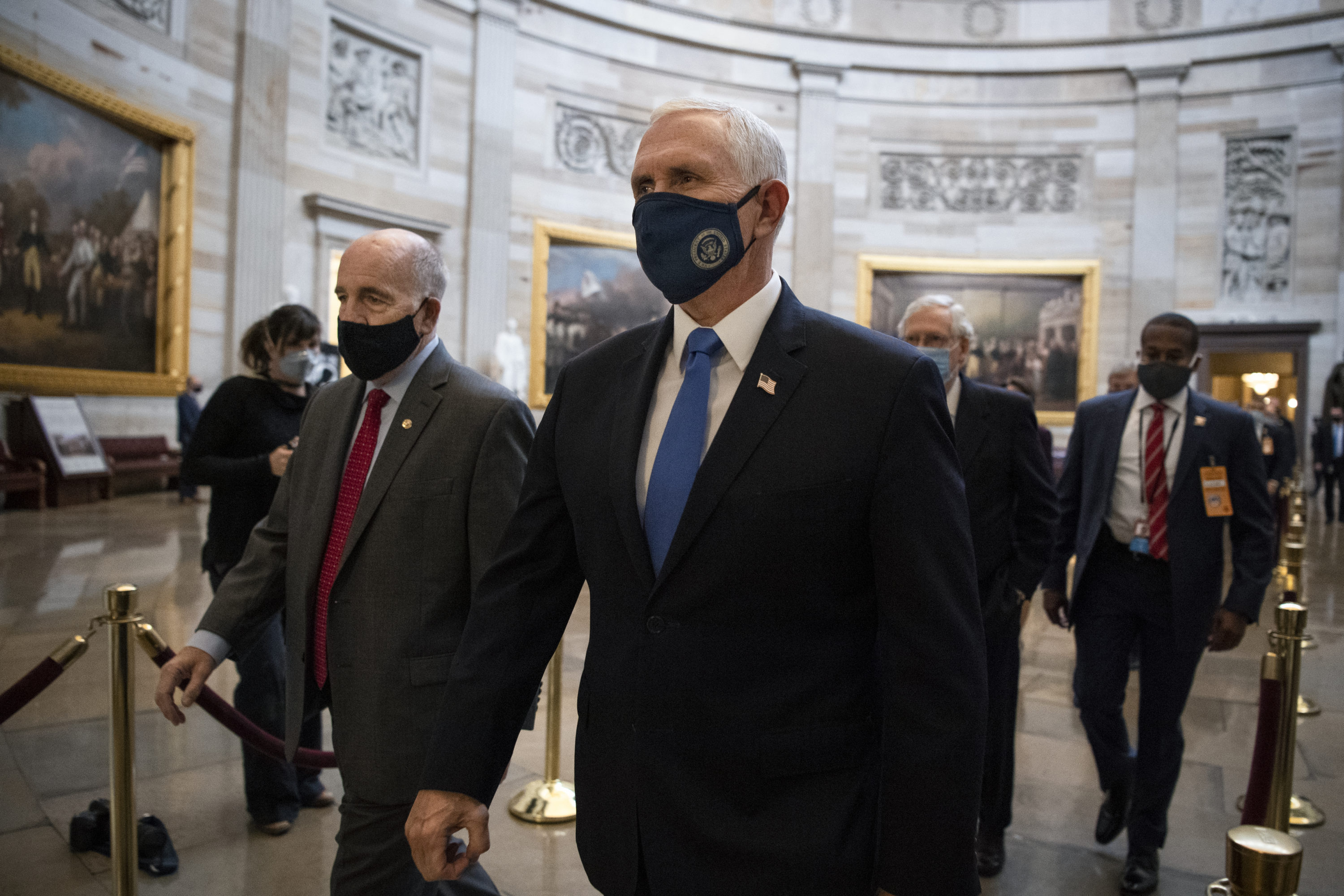 caption: Vice President Mike Pence makes his way to the House floor for a joint session of Congress to tally the electoral college votes for the president and vice president in the Capitol in Washington on Wednesday, Jan. 6, 2021. (Caroline Brehman/CQ-Roll Call, Inc via Getty Images)