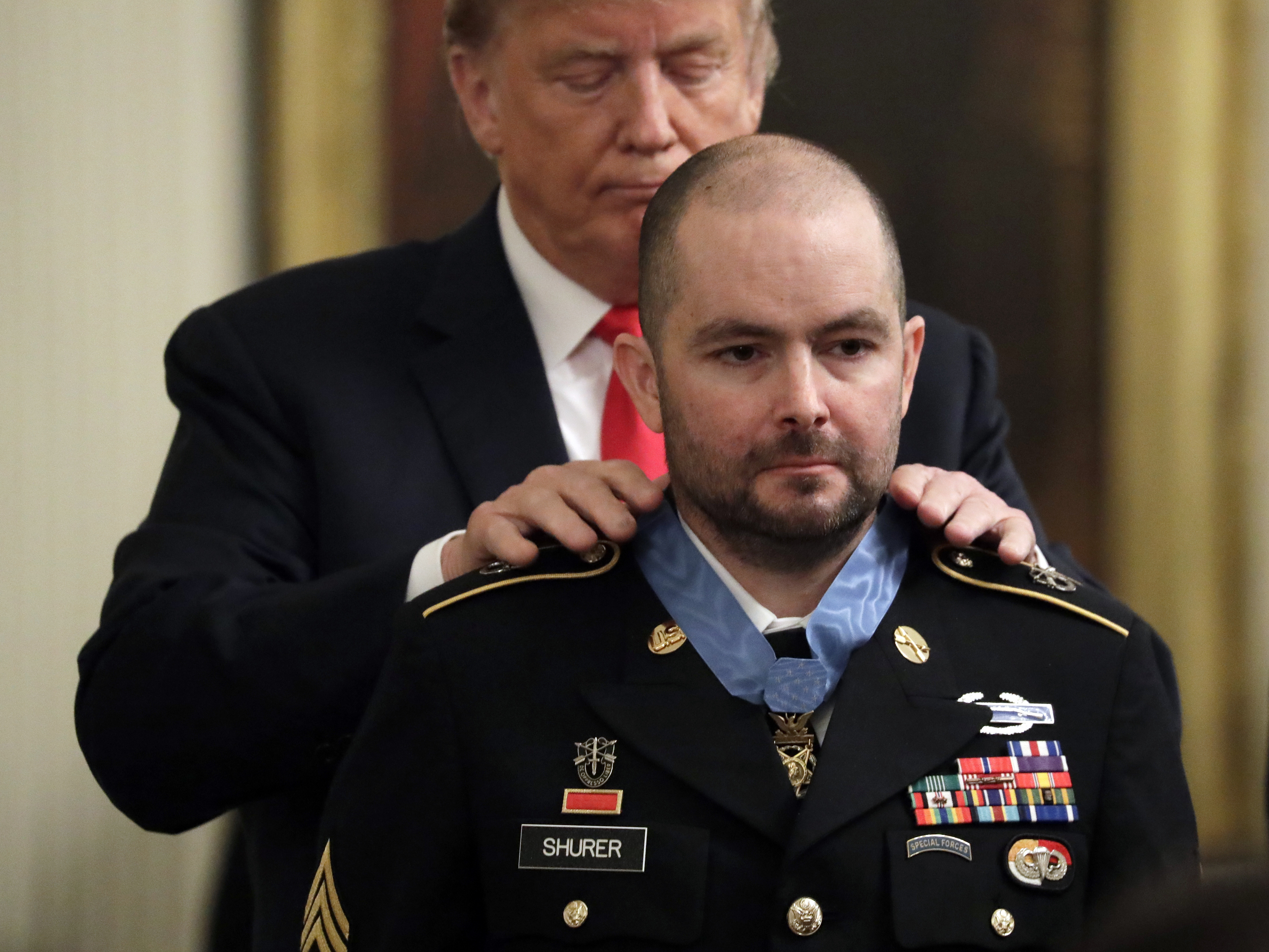 caption: President Trump awards the Medal of Honor on Monday to former Army Staff Sgt. Ronald Shurer for helping save several comrades during an intense firefight in Afghanistan in 2008. Shurer, now a Secret Service agent in Washington, is suffering from lung cancer.