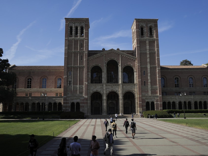 caption: University at California Los Angeles is just starting to catch up to the diversity numbers it saw before an affirmative action ban took effect in 1998, according to a university official. Students walk past Royce Hall at the UCLA campus.