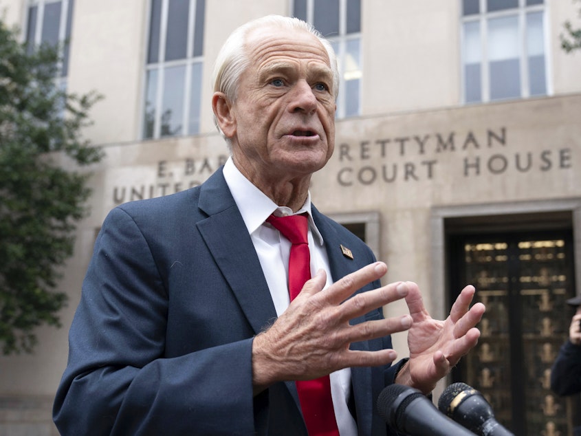 caption: Former Trump White House official Peter Navarro talks to the media as he arrives at U.S. Federal Courthouse in Washington on Thursday.