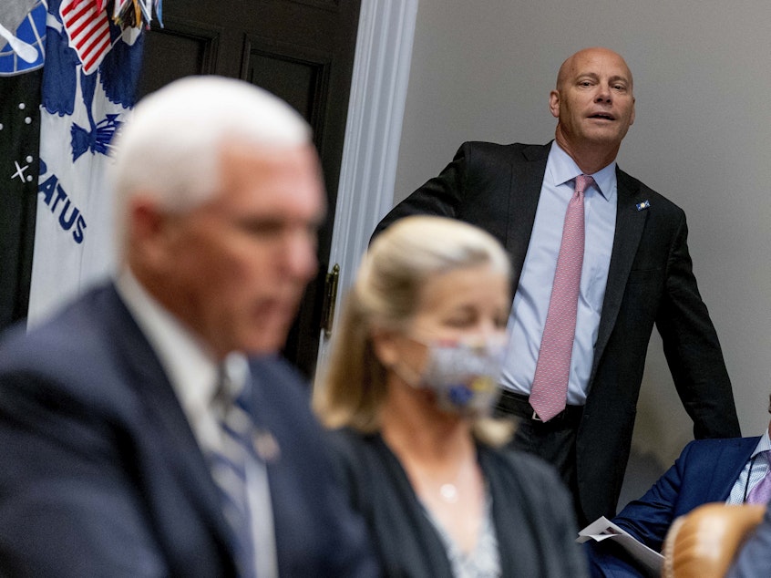 caption: Marc Short, the chief of staff to Vice President Pence, listens to Pence speak during a White House event in September. Short is the latest White House aide to test positive for the coronavirus.
