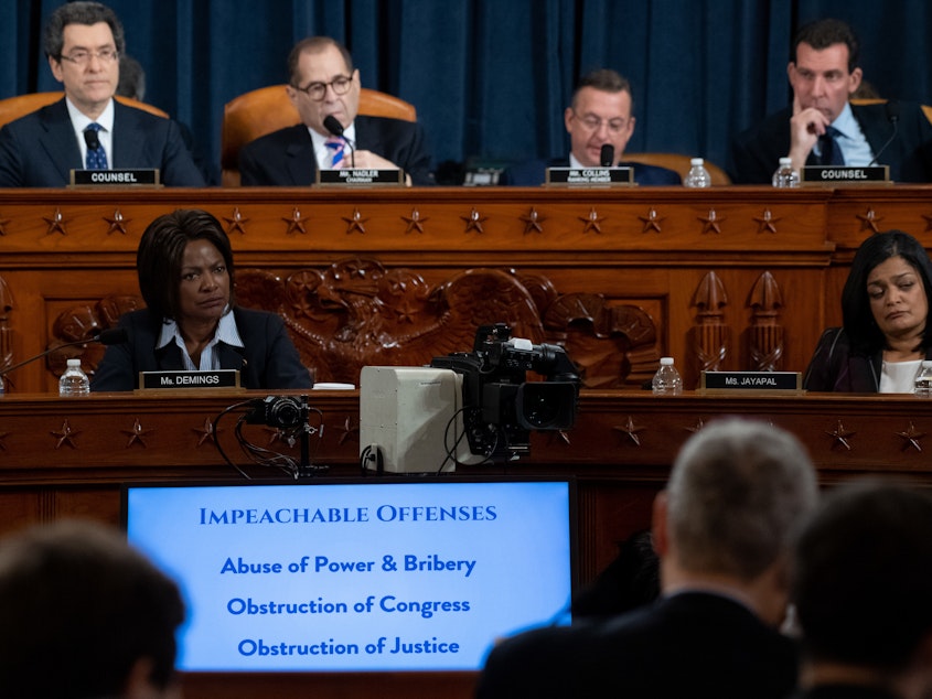 caption: Impeachable offenses were listed on a monitor as the House Judiciary Committee listened to testimony by constitutional scholars earlier this week.