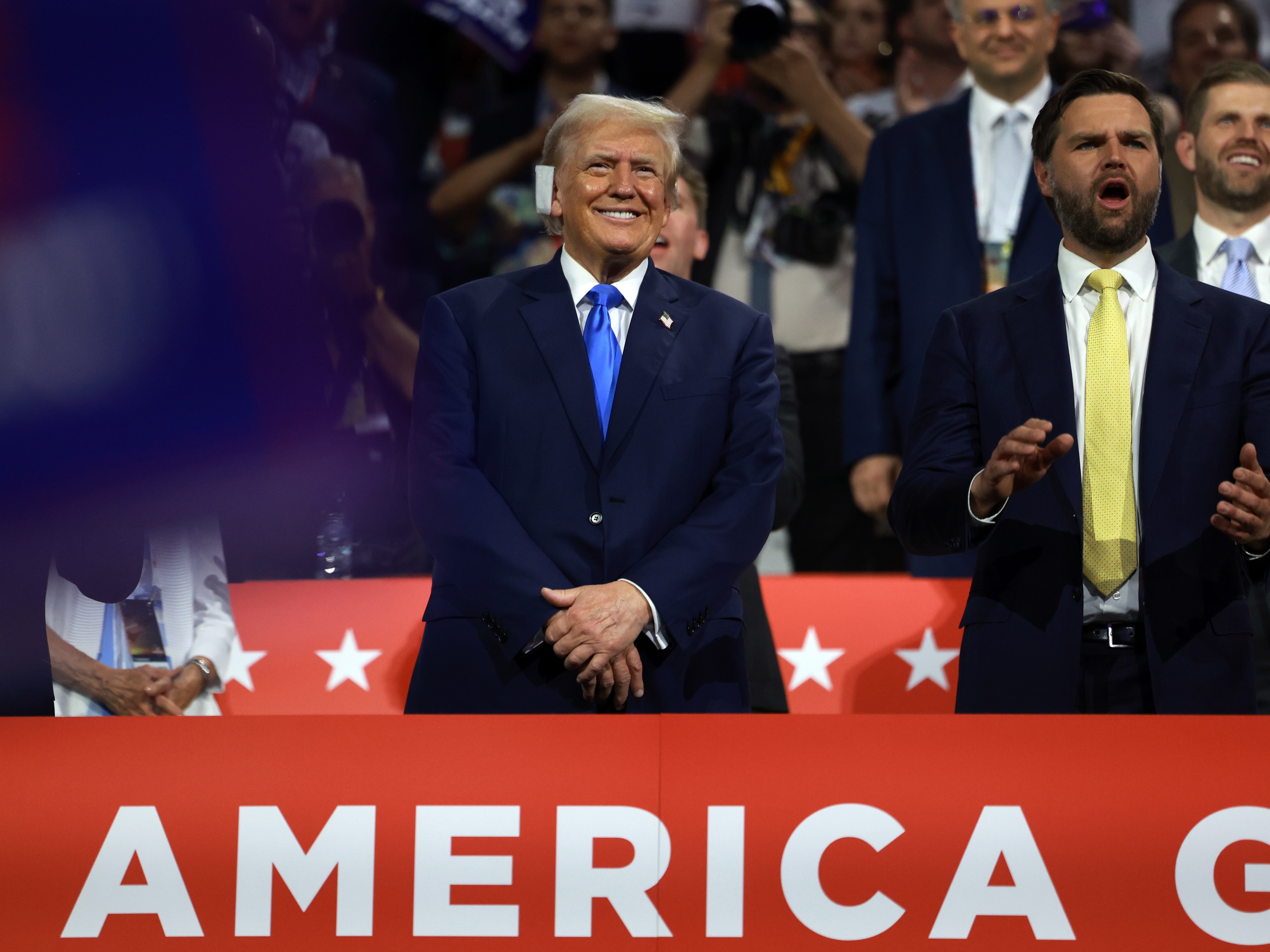 caption: Republican presidential candidate Donald Trump and vice presidential candidate J.D. Vance at the Republican National Convention in Milwaukee on Tuesday.