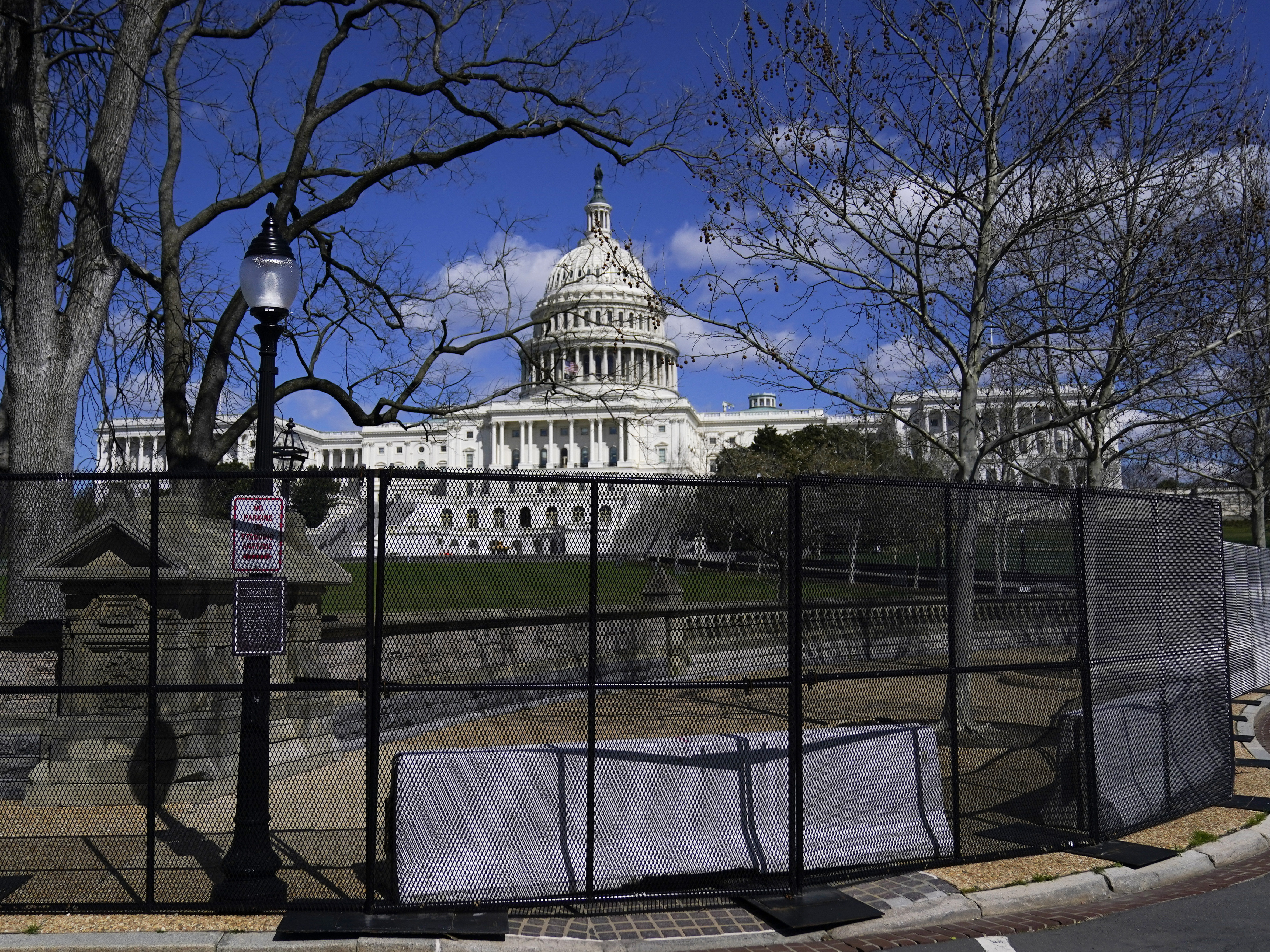 caption: In this April 2, 2021, file photo the U.S. Capitol is seen behind security fencing on Capitol Hill in Washington.