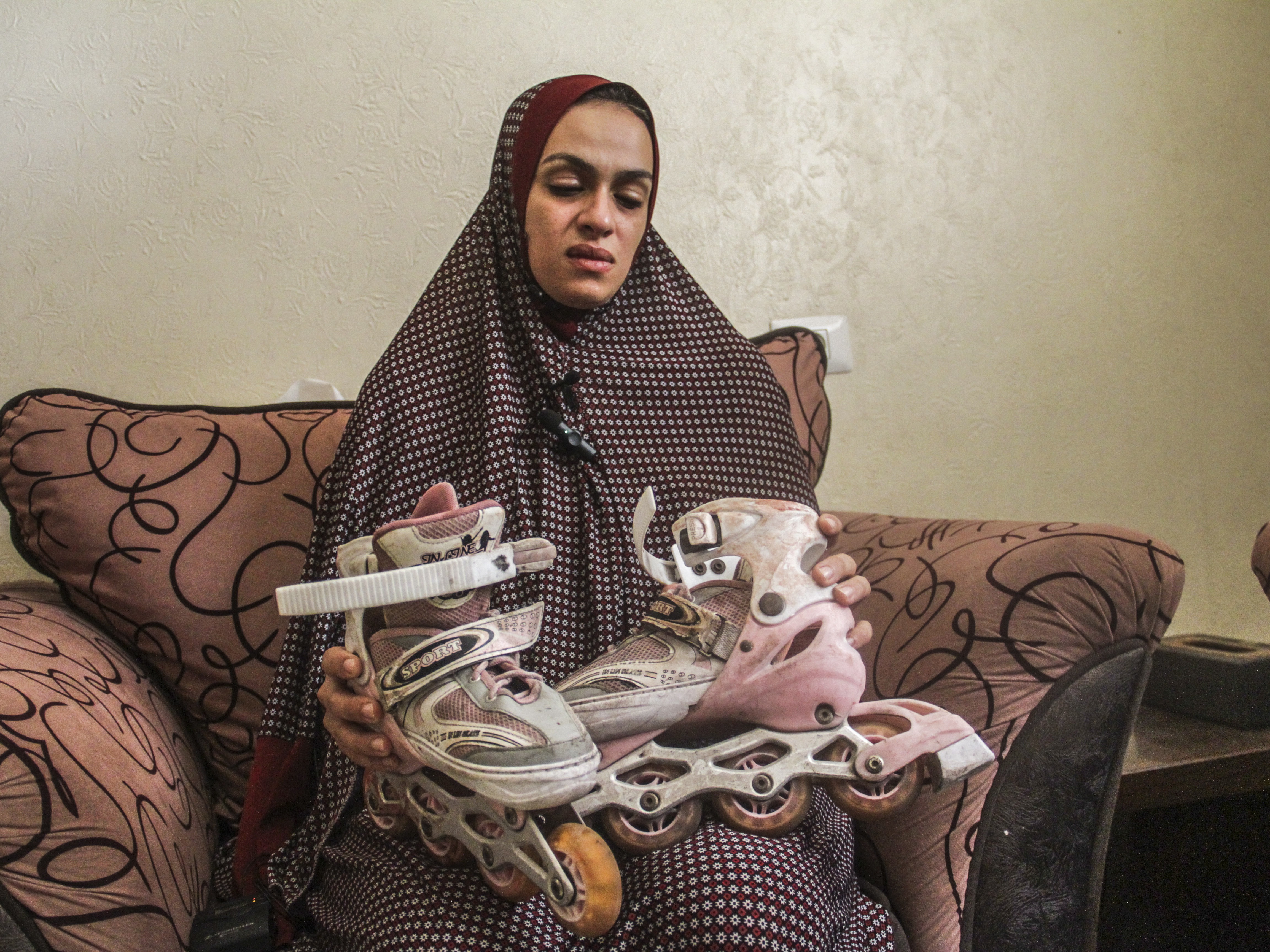 caption: A Palestinian family mourns the death of their daughter, who was killed in an Israeli attack as she was heading to play while wearing her roller skates, in Gaza City, Gaza, on Sept. 4.