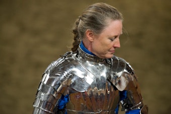 caption: Dame Richildis, aka Ann Shilling, has a quiet moment between rounds of jousting as the Seattle Knights perform on April 12, 2014, at Rhodes River Ranch in Oso.