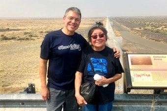 caption: Physicist Corey Gray and his mother, Sharon Yellowfly, are pictured at one of the two massive detectors that make up the Laser Interferometer Gravitational-Wave Observatory. One facility, where Gray works, is in Hanford, Wash., and the other is in Louisiana.Courtesy of Russell Barber