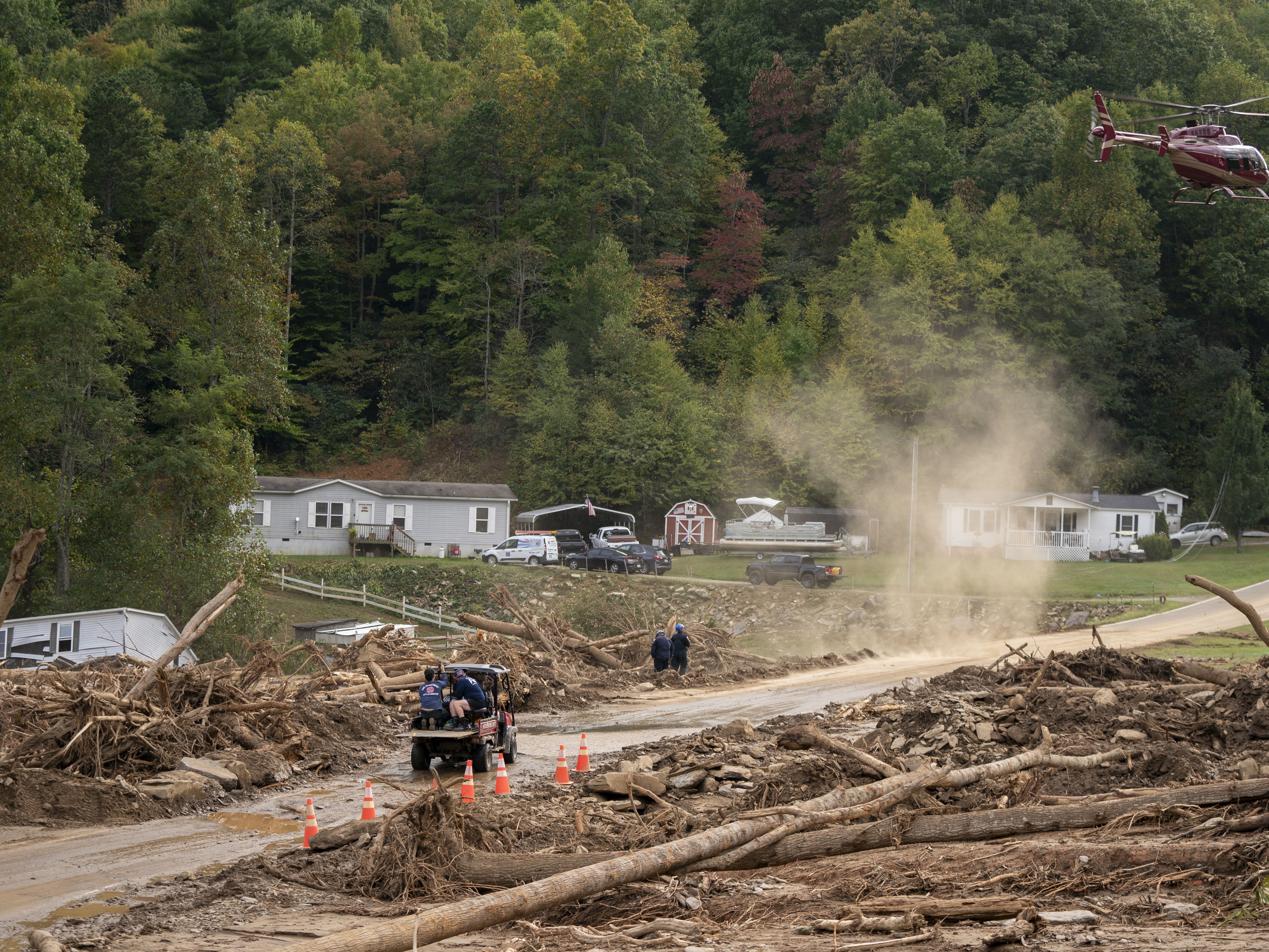 caption: A helicopter lands in a yard in the aftermath of Hurricane Helene on Monday near Black Mountain, N.C.