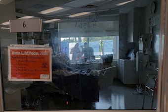 caption: Family members gather outside the window of a COVID-19 patient at Lake Regional Hospital in Osage Beach, Mo., on Monday.
