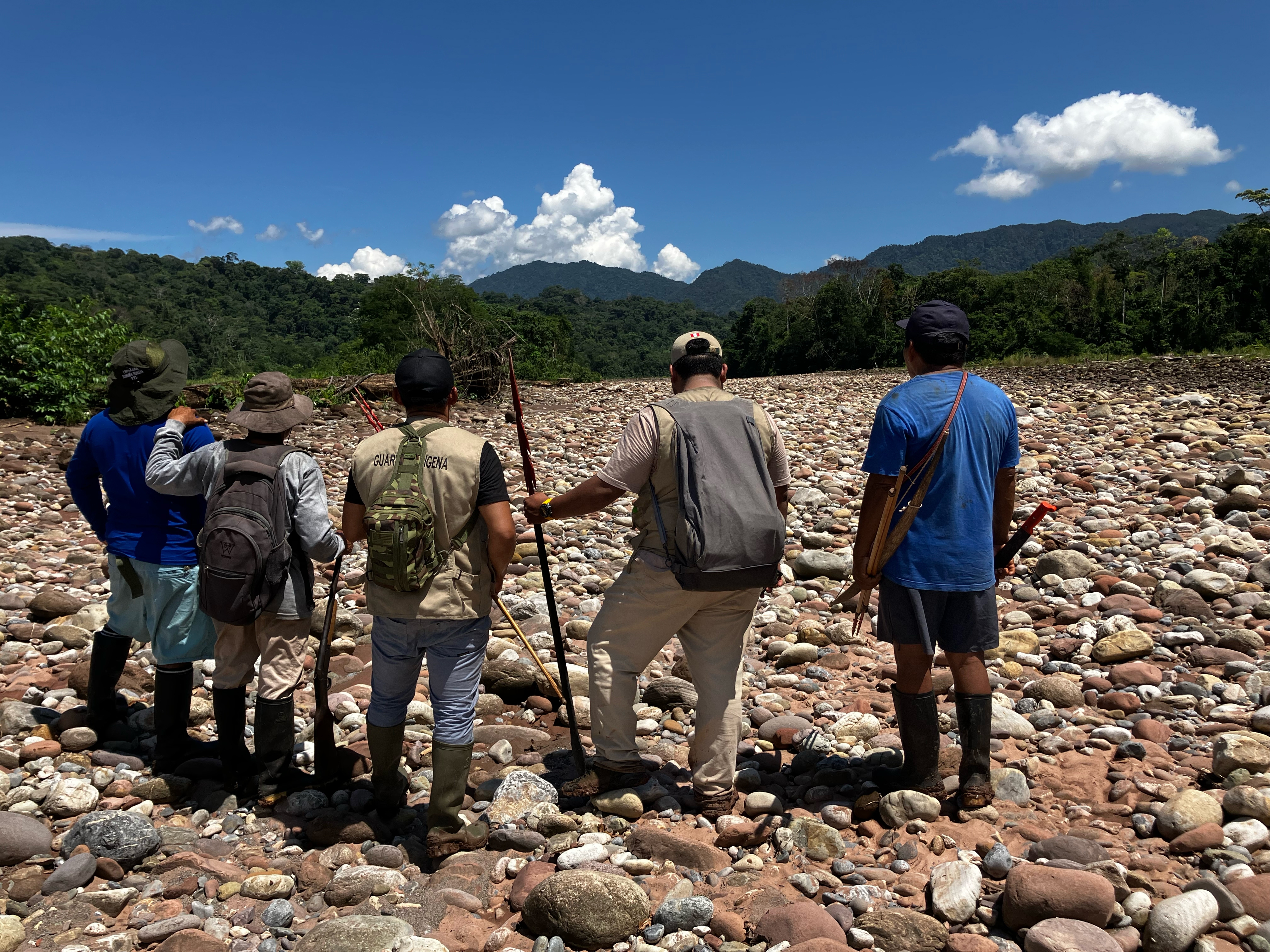 caption: Members of the Kakataibo Indigenous Guard who patrol the Peruvian Amazon, watching for coca crops being planted in the rainforest — a source of deforestation, violence, and bloodshed on their land.