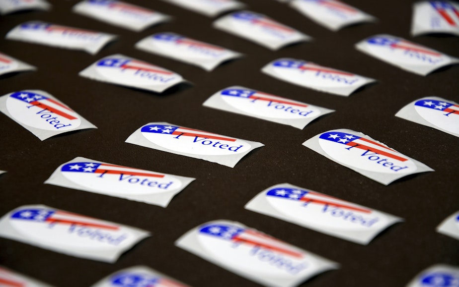 caption: "I Voted" stickers are displayed at a polling place in Cheyenne, Wyo. on Aug. 16, 2022.