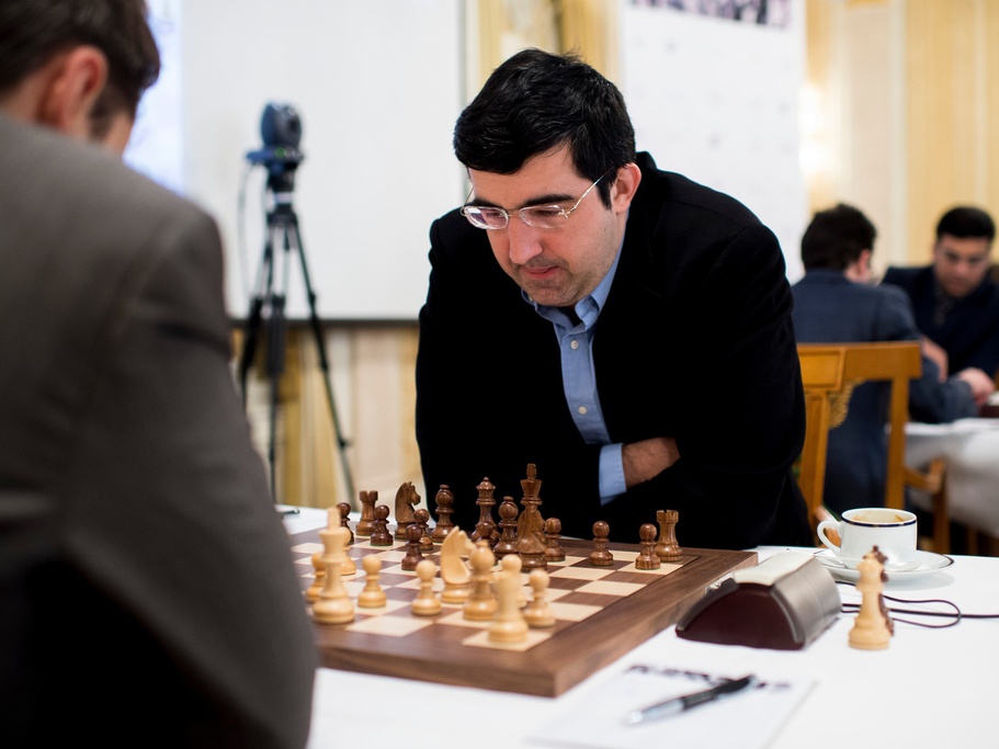 caption: Russian chess grandmaster Vladimir Kramnik, right, concentrates during a February 2015 game against U.S. grandmaster Lewon Aronjan during the Zurich Chess Challenge.