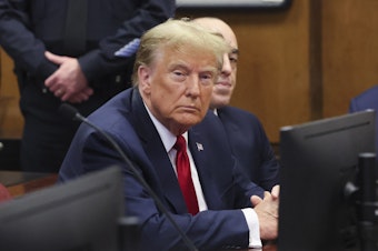 caption: Former President Donald Trump attends a pre-trial hearing Thursday for charges he faces in a New York hush money case. Two civil judgments in New York put Trump on the hook for hundreds of millions of dollars.
