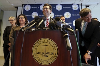 caption: Washington state Attorney General Bob Ferguson smiles during a news conference about President Trump's new executive order Monday, March 6, 2017, in Seattle. 