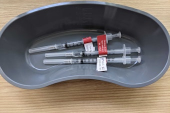 caption: Needles containing the newly approved Covid-19 vaccine for children between the ages of 6 months and 5 years sit in a container at Children's Hospital on June 21.