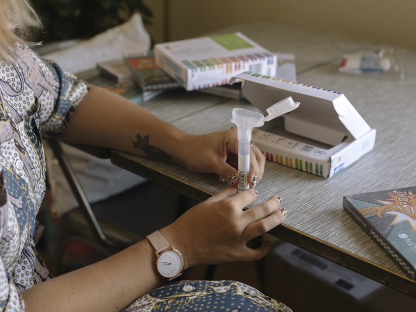 caption: Many at-home DNA ancestry testing kits require participants to mail in a sample of saliva.