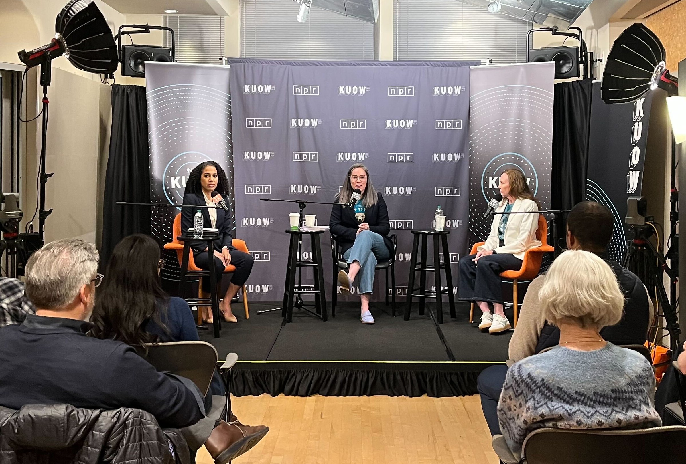 caption: KUOW's Libby Denkmann moderates a debate between the two candidates for Seattle City Attorney — challenger Erika Evans on the left and incumbent Ann Davison on the right.