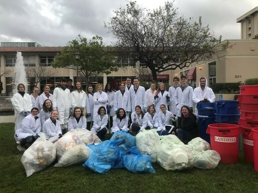 caption: Professor Stephanie Hughes and students categorizing various types of waste in January 2020.