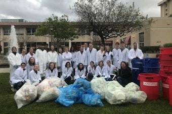 caption: Professor Stephanie Hughes and students categorizing various types of waste in January 2020.