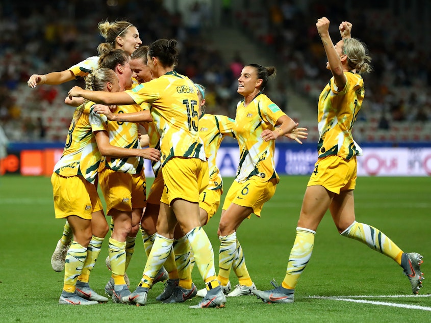 caption: Australia celebrates a goal during its knockout round match against Norway during the Women's World Cup in France in June. Football Federation Australia announced a new deal on Wednesday to improve pay and conditions for the women's team, known as the Matildas.