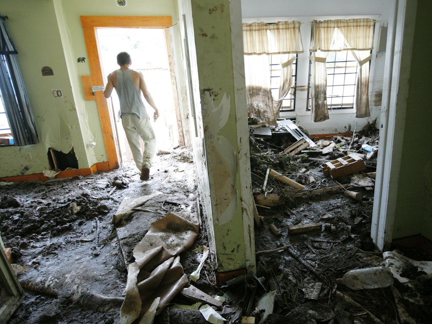 caption: Hurricane Irene caused enormous damage in New York state, flooding homes like this one in Prattsville, NY, in 2011. Major weather events like Irene send people to the hospital and can even contribute to deaths for weeks after the storms.