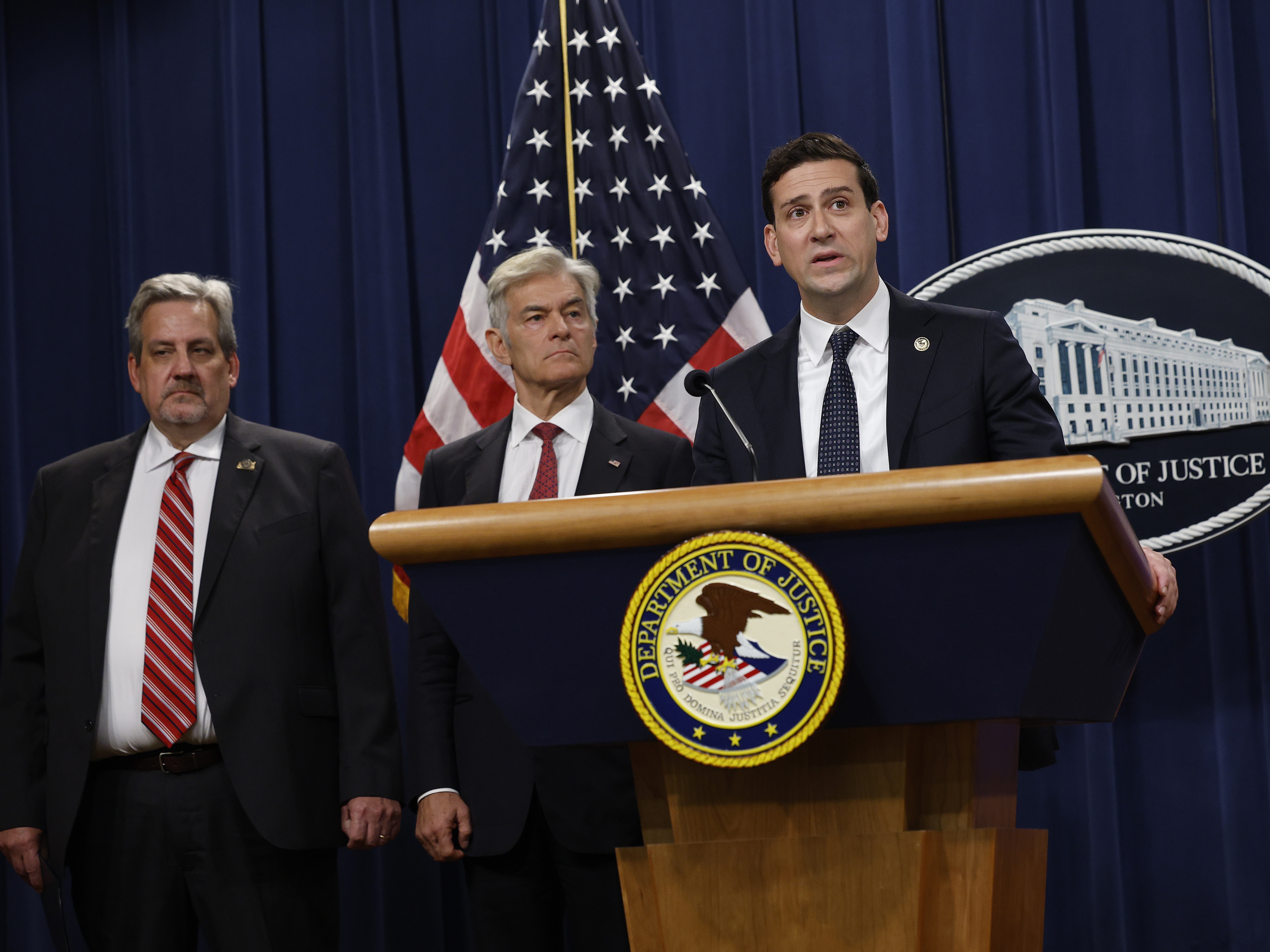 caption: Matthew Galeotti, head of the Justice Department's Criminal Division, delivers remarks during a press conference at the Department of Justice on June 30. Galeotti is shown with Assistant Administrator of the Drug Enforcement Agency Thomas Prevoznik and Administrator for the Centers for Medicare and Medicaid Services Mehmet Oz.