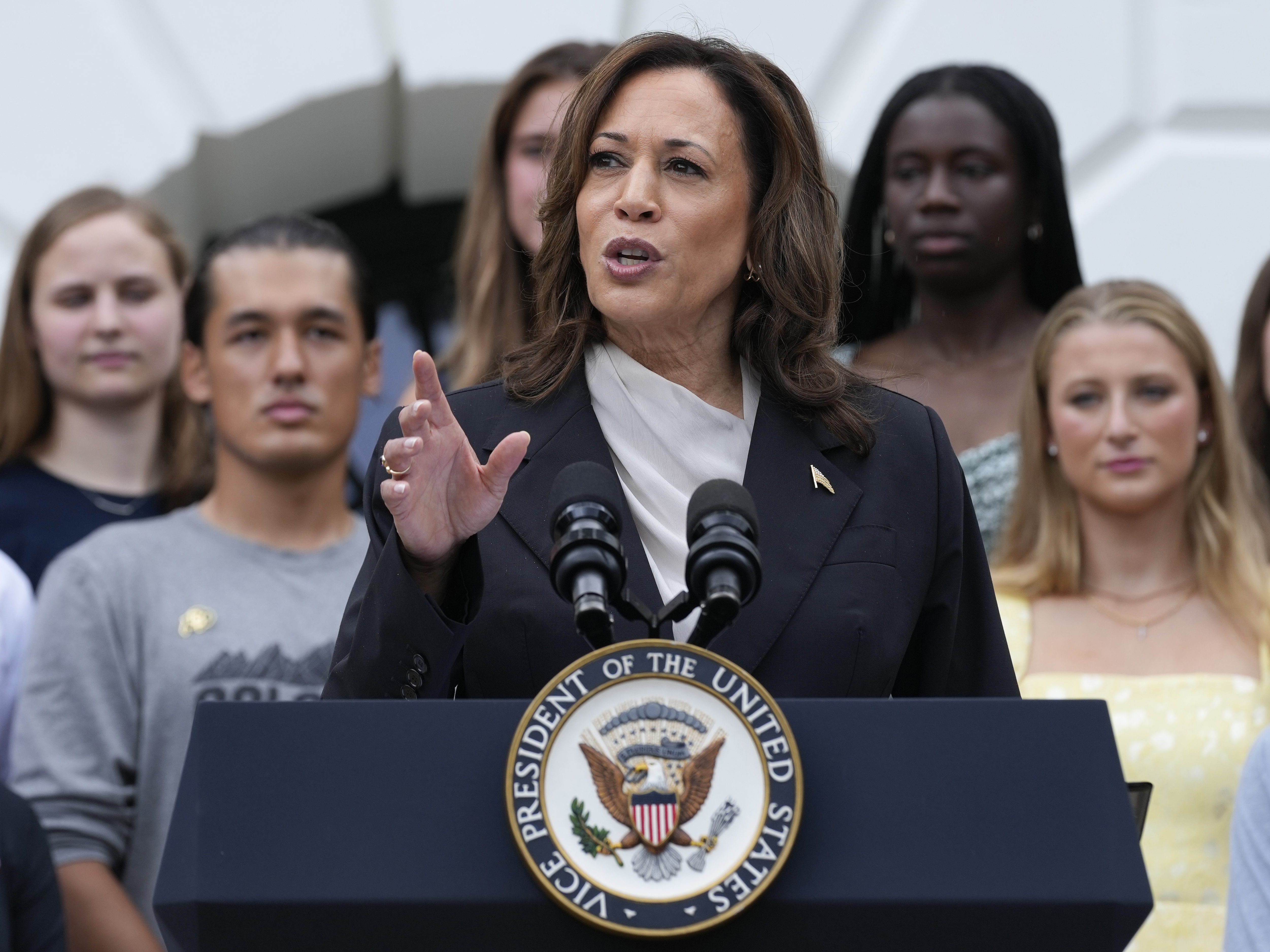 caption: Vice President Kamala Harris speaks from the South Lawn of the White House in Washington on Monday during an event with NCAA college athletes. 