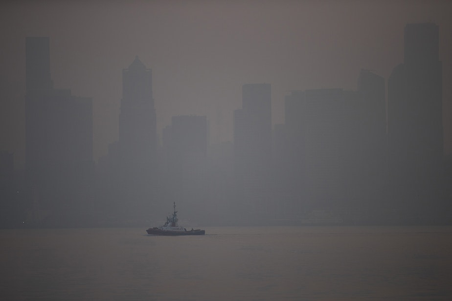 caption: The sun comes up over Seattle as a massive plume of smoke from wildfires burning in California and Oregon made it's way into the area, on Friday, September 11, 2020, in Seattle. 