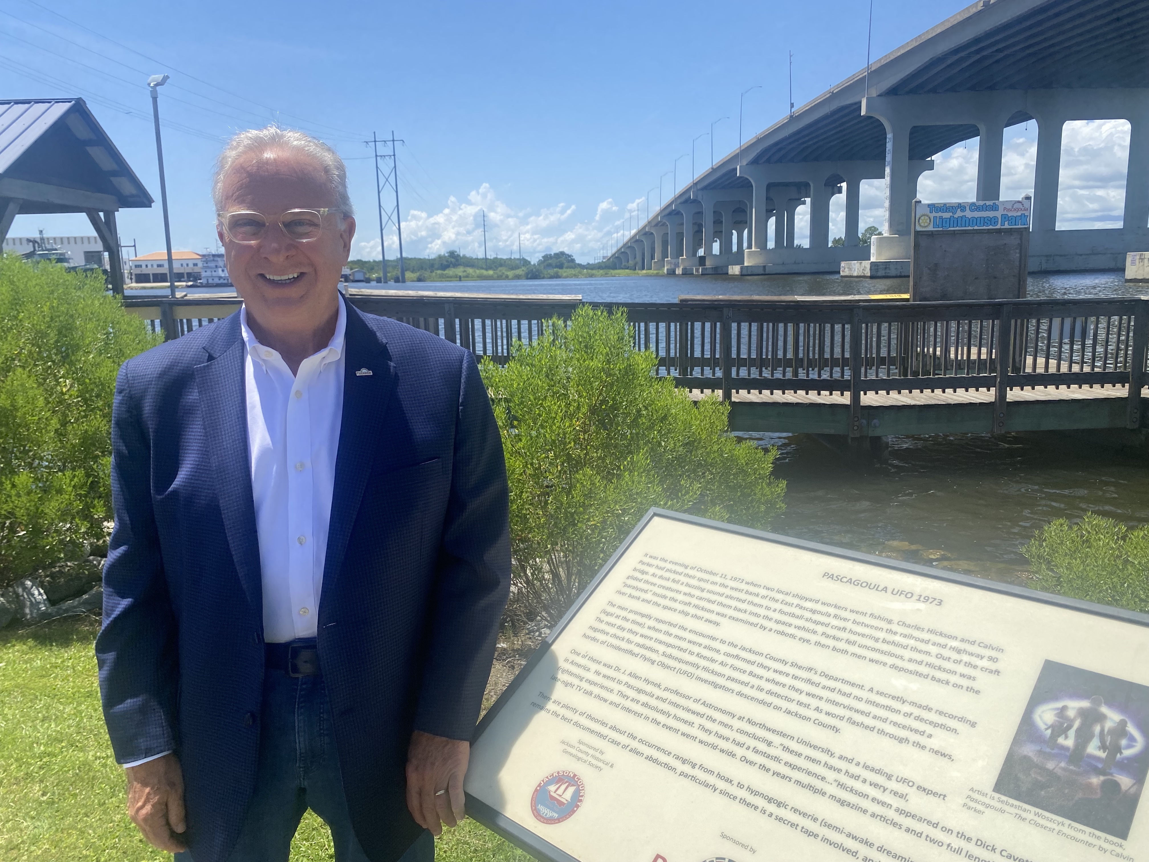 caption: Pascagoula Mayor Jay Willis stands next to a historical marker that claims aliens came from outer space and abducted two local men in 1973. 