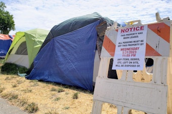 caption: A homeless encampment was forced off of public property in Burien in May.