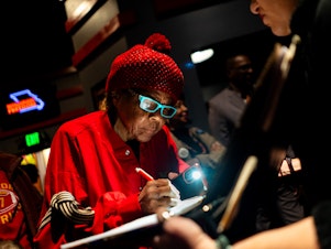 caption: Janice Jernigans, 75, of St. Louis' Hyde Park neighborhood, signs a petition for a Missouri constitutional amendment that would legalize abortion up until fetal viability on Feb. 6 at The Pageant in St. Louis.