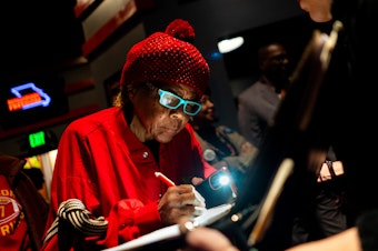 caption: Janice Jernigans, 75, of St. Louis' Hyde Park neighborhood, signs a petition for a Missouri constitutional amendment that would legalize abortion up until fetal viability on Feb. 6 at The Pageant in St. Louis.