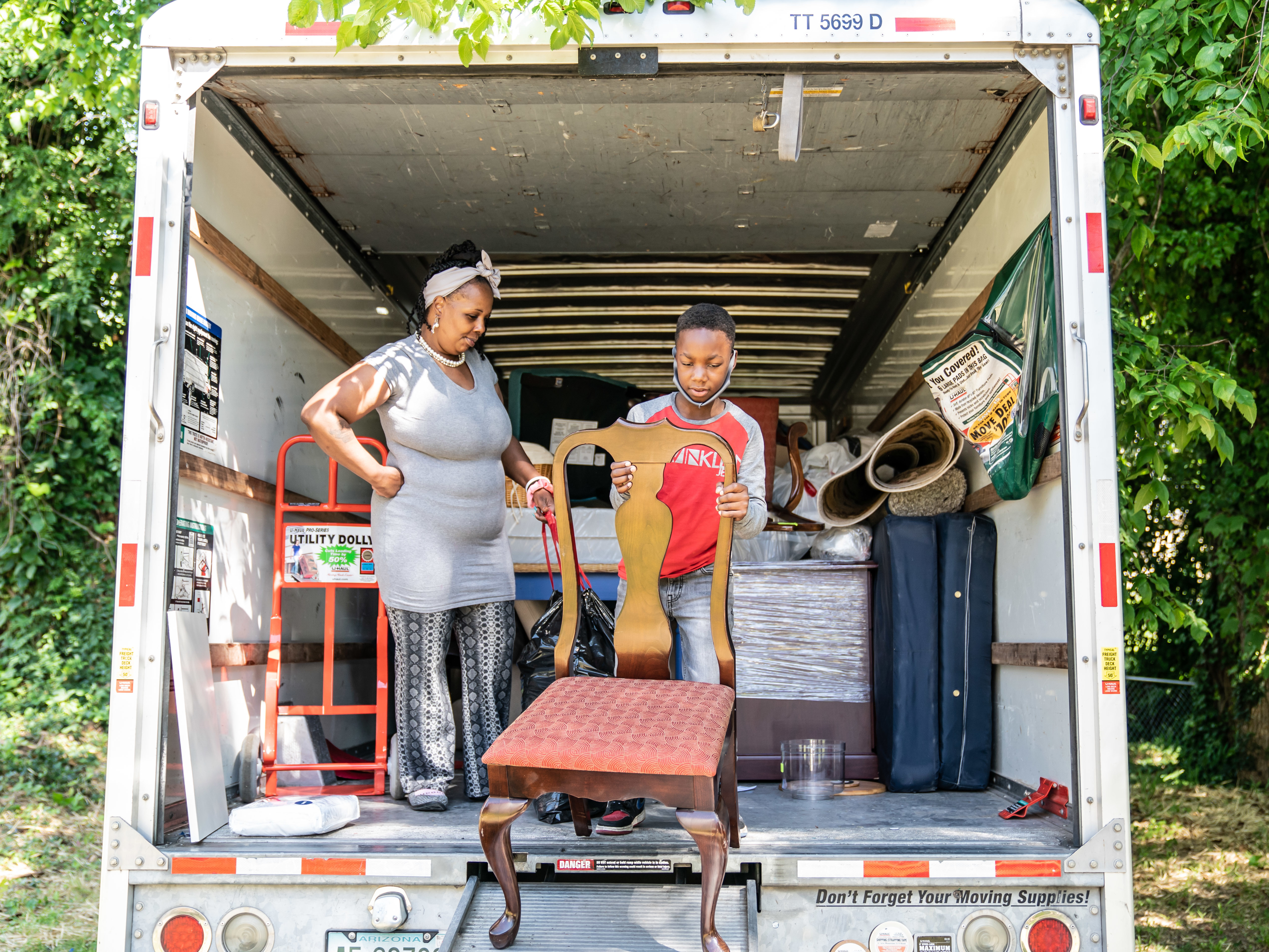 caption: Tasharn Richardson's 11-year-old son, Lionel, helps unload the moving truck at their new home in Washington, D.C. To Tasharn, having a house to call her own always seemed like someone else's dream.