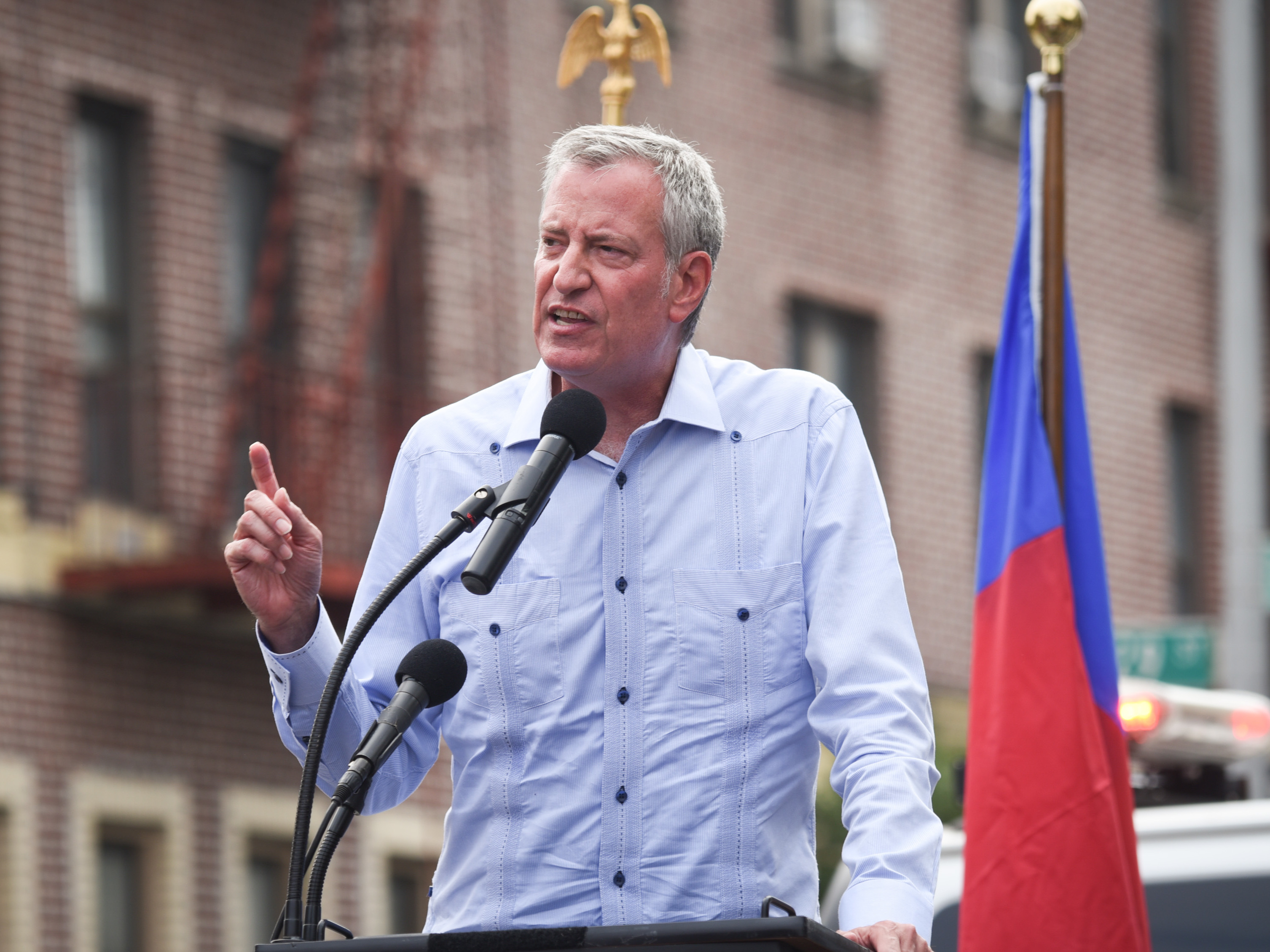 caption: New York City Mayor Bill de Blasio said Monday that city workers will be required to be vaccinated or get tested weekly for COVID-19. De Blasio is seen here in Brooklyn on Sunday at a rally in support of Haiti.